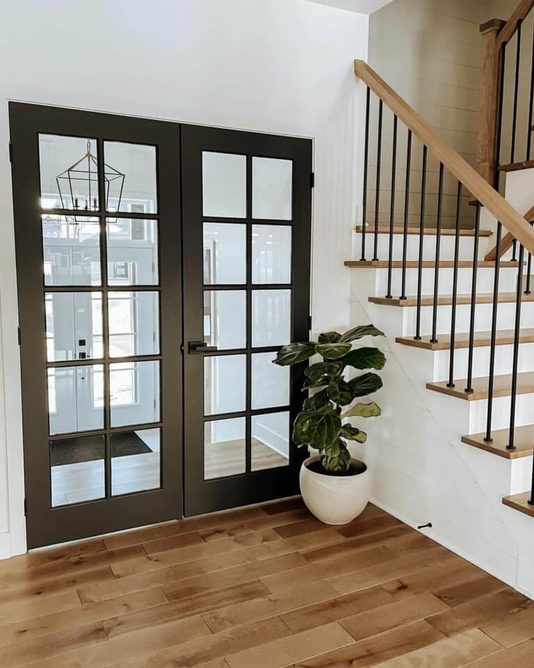 Black French Doors and Wood Staircase