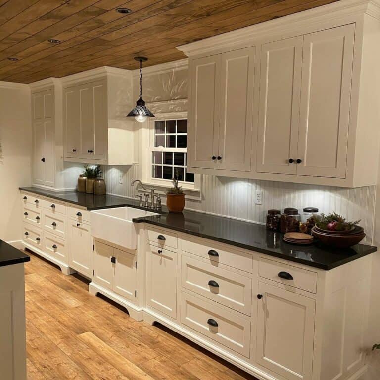 Black Kitchen Countertop With Natural Wood Ceiling