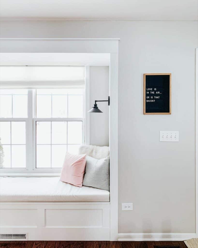 Black Sconce Illuminates Window Alcove