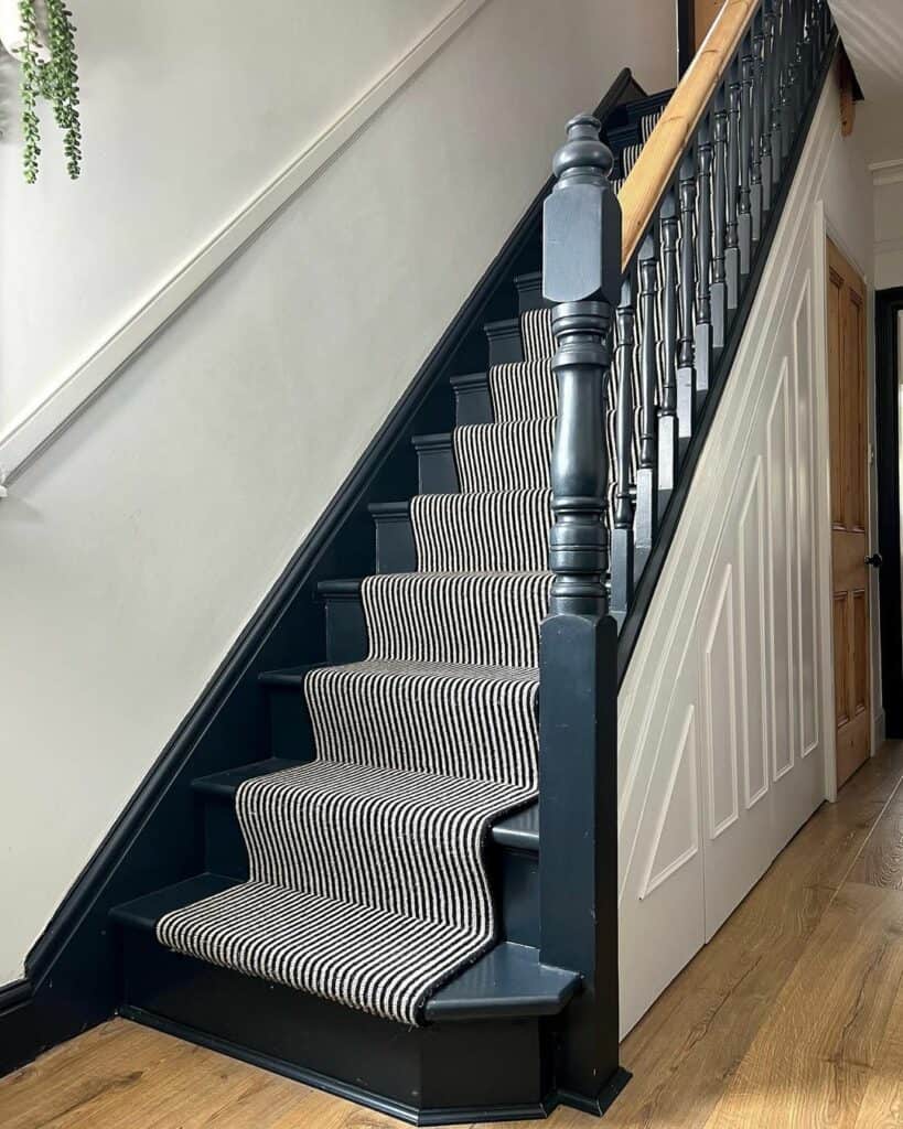 Black Staircase With Striped Runner