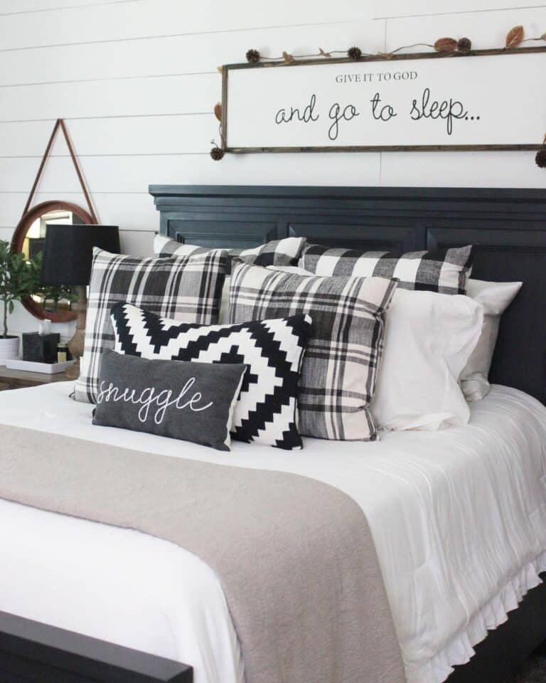 Black and White Farmhouse Bedroom With Patterned Pillows