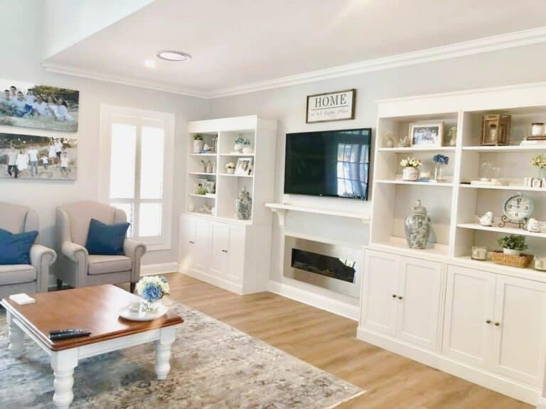 Blue Accented Living Room With White Fireplace Cabinets
