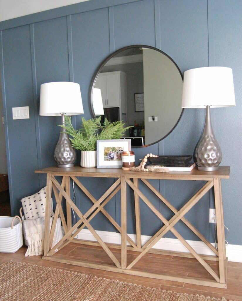 Blue Board and Batten Entryway With Round Mirror