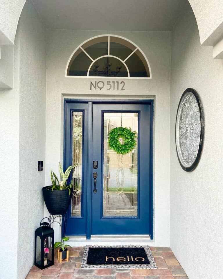 Blue Front Door With Round Wall Décor