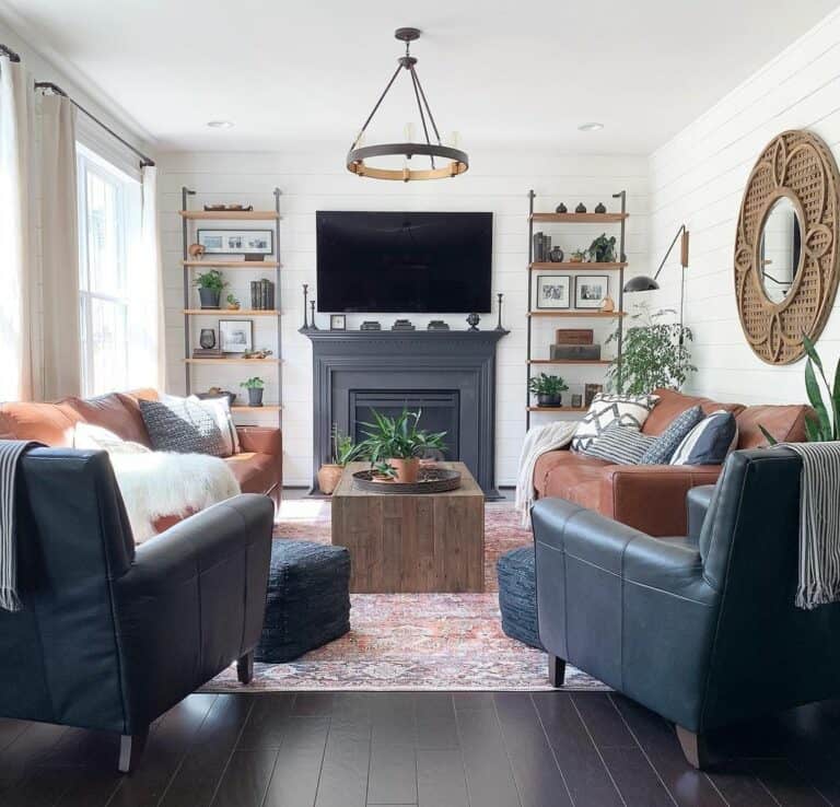 Circular Mirror in Large Frame Above Brown Leather Sofa