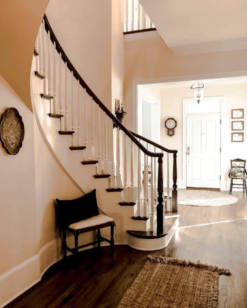 Curving White Staircase With Dark Wood Treads