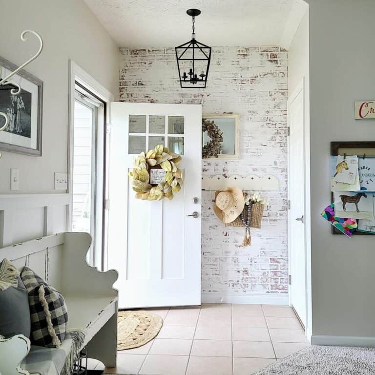 Entry Foyer With White Painted Brick Accent Wall