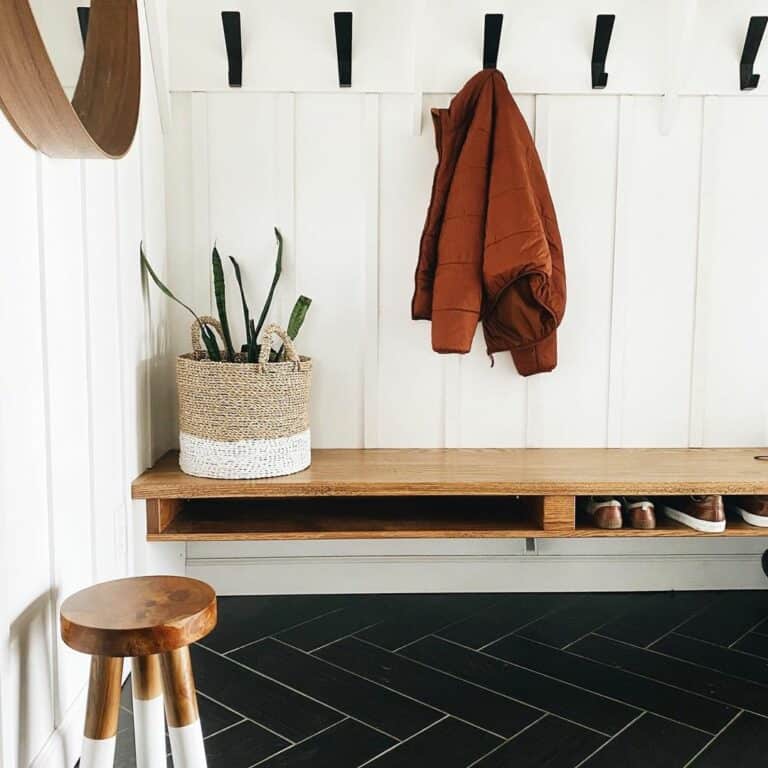 Entryway Mudroom With Black Herringbone Floor Tiles