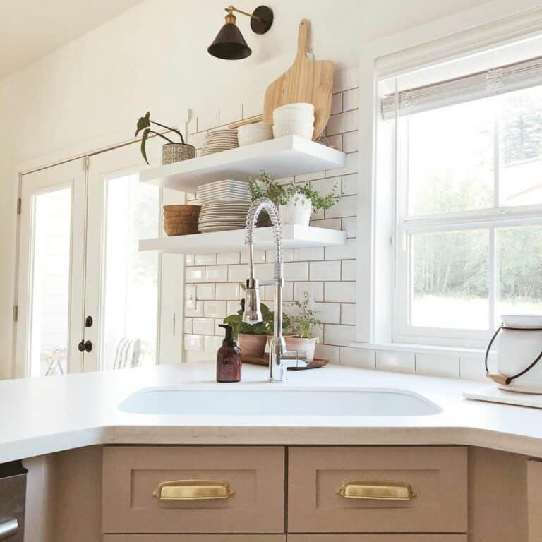 Farmhouse Kitchen With White Floating Shelves and Greenery