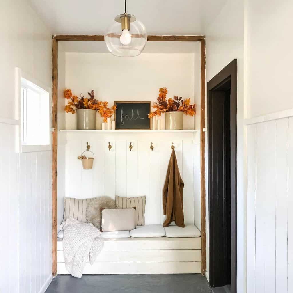 Farmhouse Mudroom With White Bench and Fall Accents