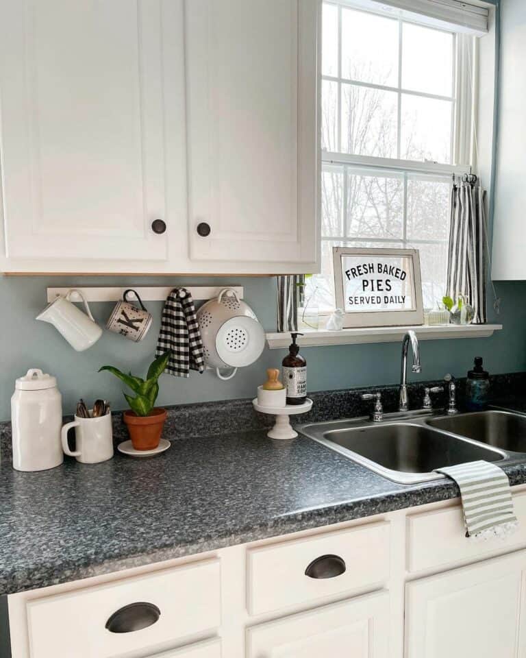 Granite Countertop With Soft Blue Walls in Farmhouse Kitchen