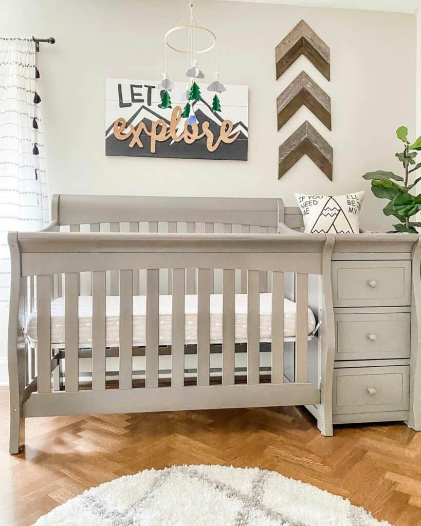 Gray Crib With Rustic Wood Wall Décor