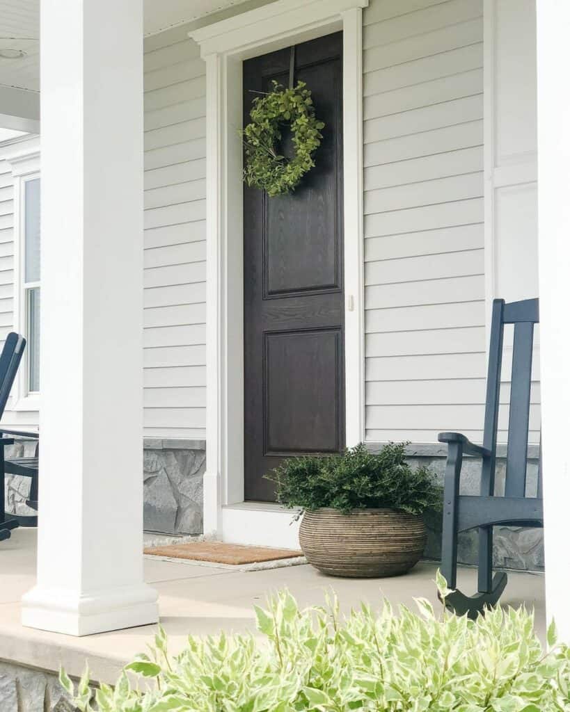 Gray Porch With Black Door and White Trim
