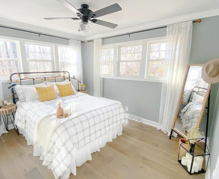 Gray and White Bedroom With Yellow Pillows