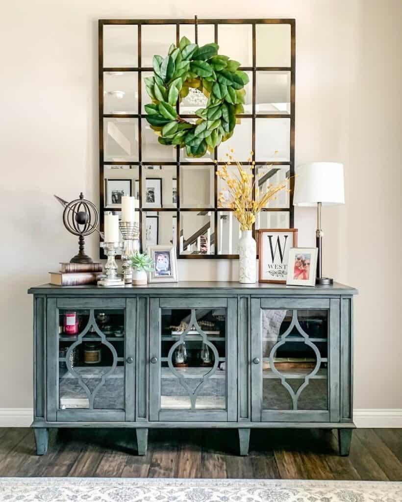 Green Wreath Over Mirrored Blue Console Table