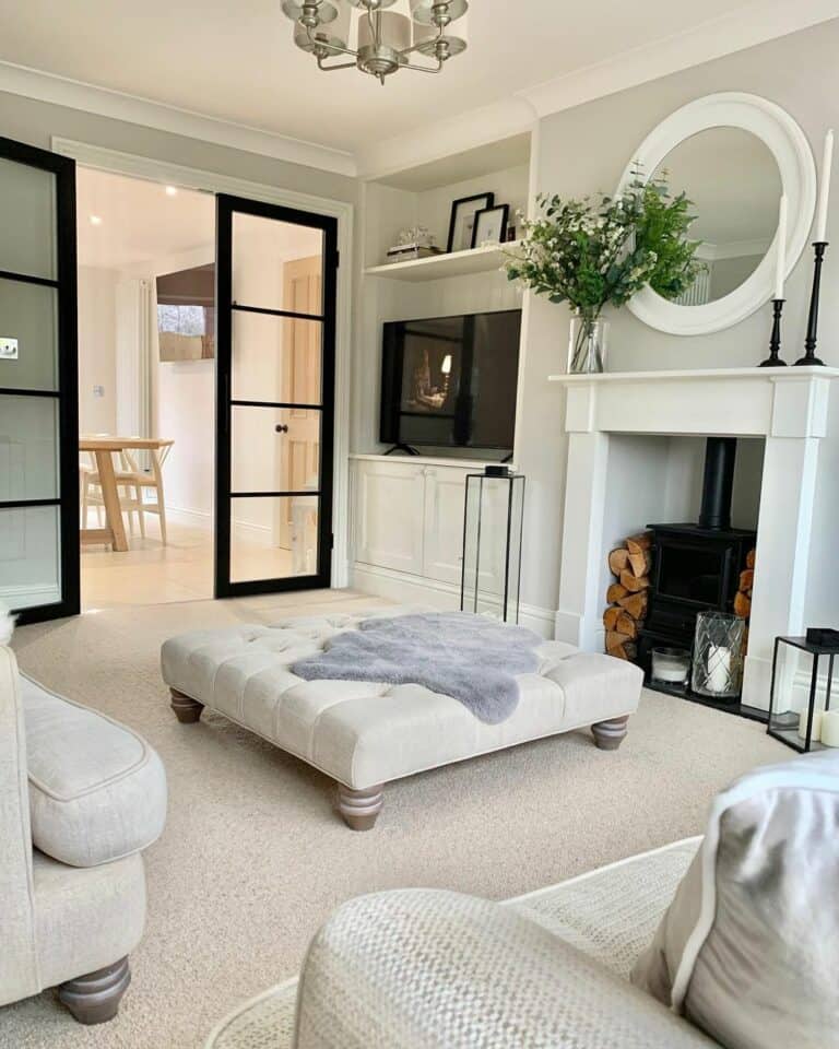 Interior Black Glass Doors and a White Ottoman