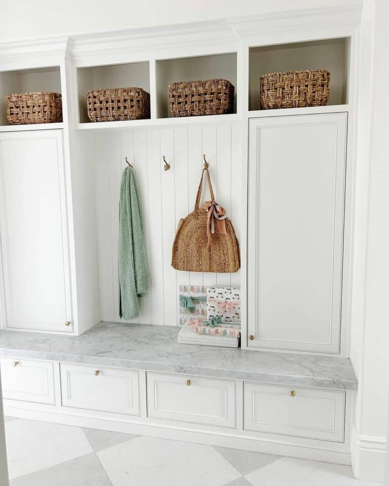 Light Gray and White Mudroom With Rattan Accents