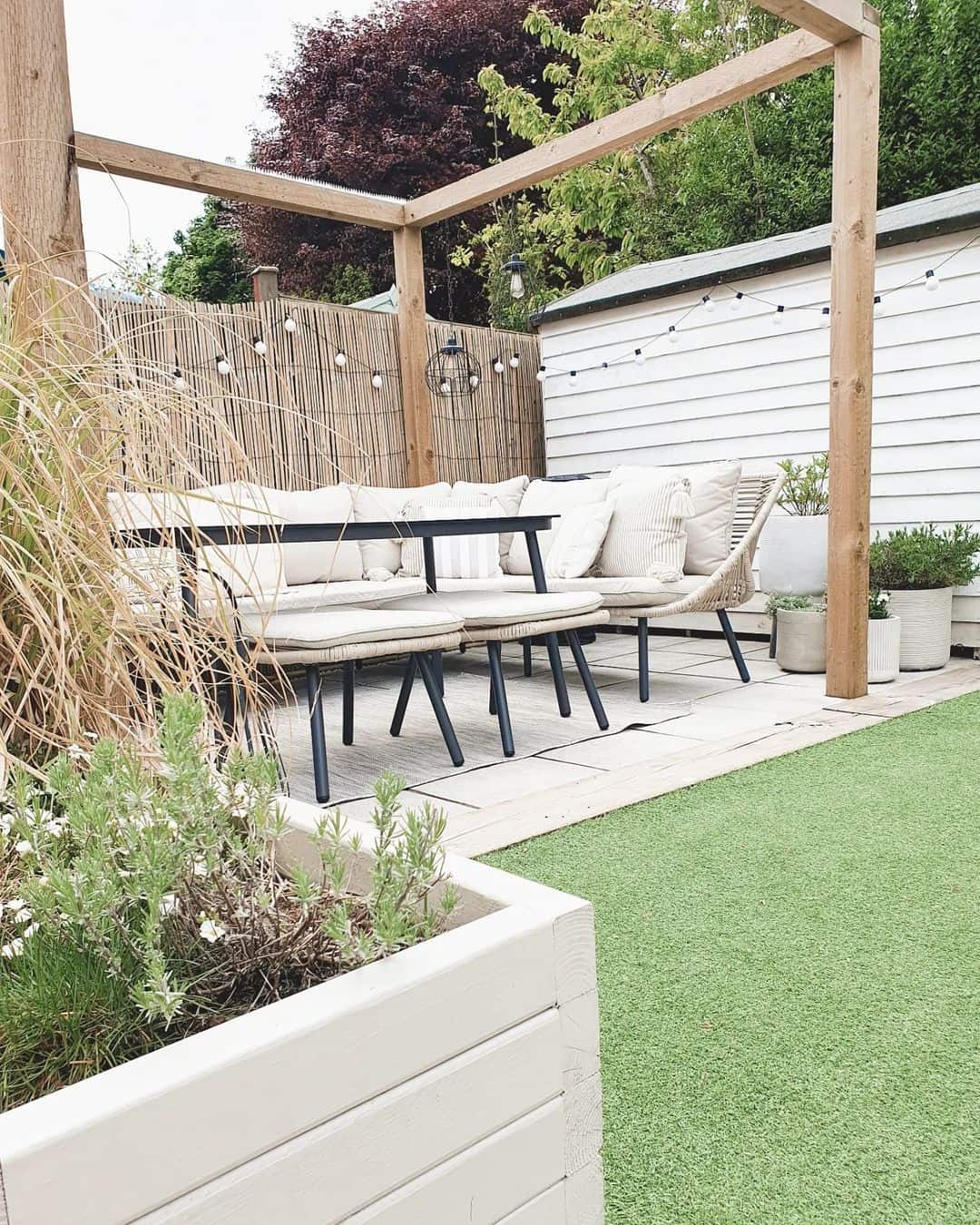 Light Wood Outdoor Pergola With Beige Wicker Sectional Soul & Lane