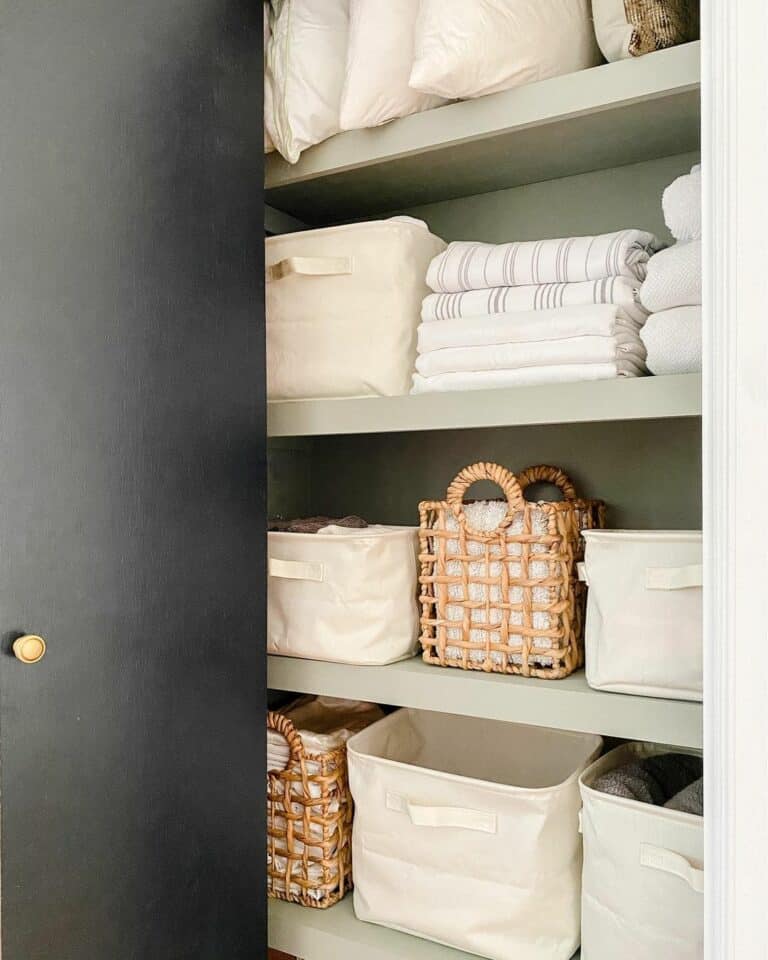 Linen Closet With Canvas Caddies and Wicker Baskets
