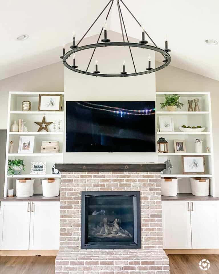 Living Room With Red-brick Fireplace and White Cabinets