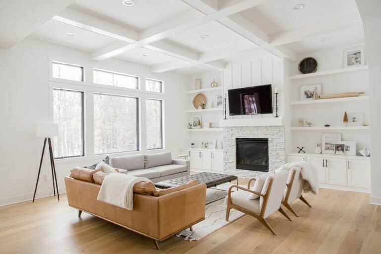 Living Room With White-stone Fireplace and Cabinets