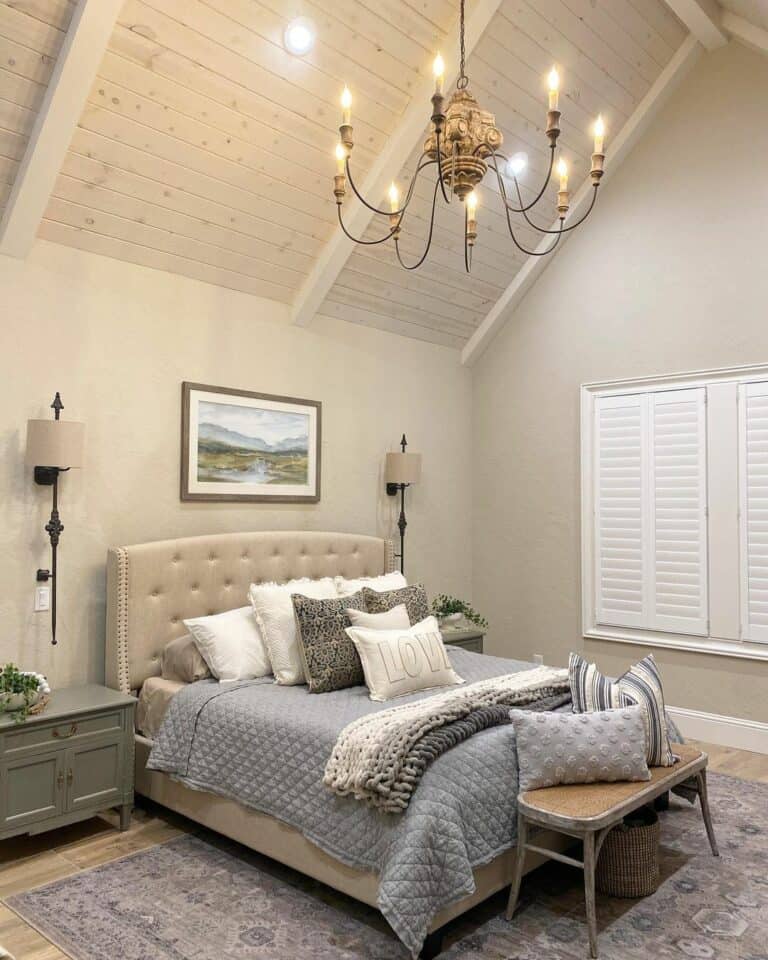 Master Bedroom With Chandelier and Black-accented Sconce