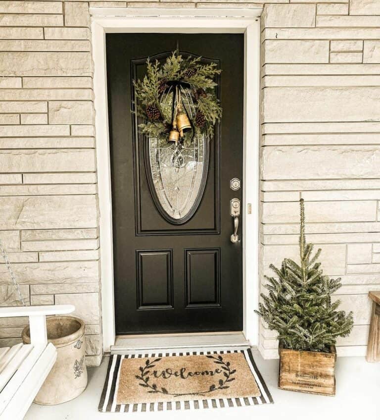 Matte Black Front Door With White Stone Exterior