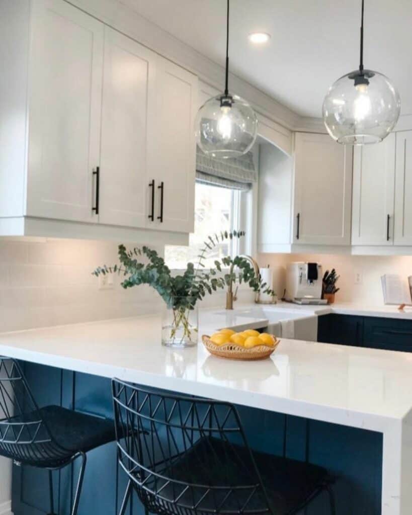 Modern White and Navy Kitchen With Black Woven Chairs