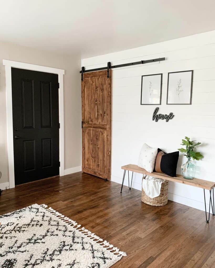 Neutral Entryway With Black Doors and White Trim