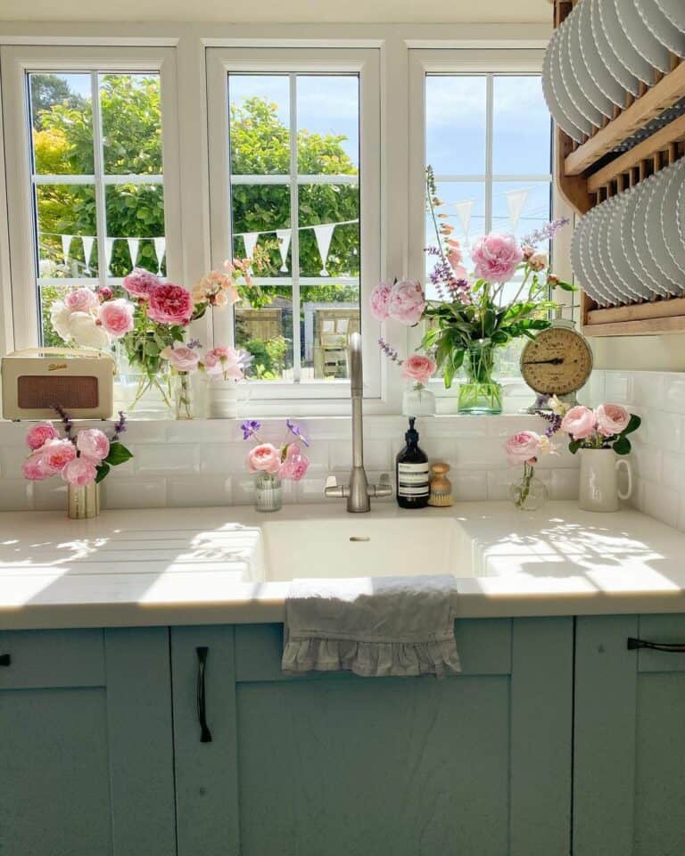 Pink Flowers in Glass Jars on a Window Sill