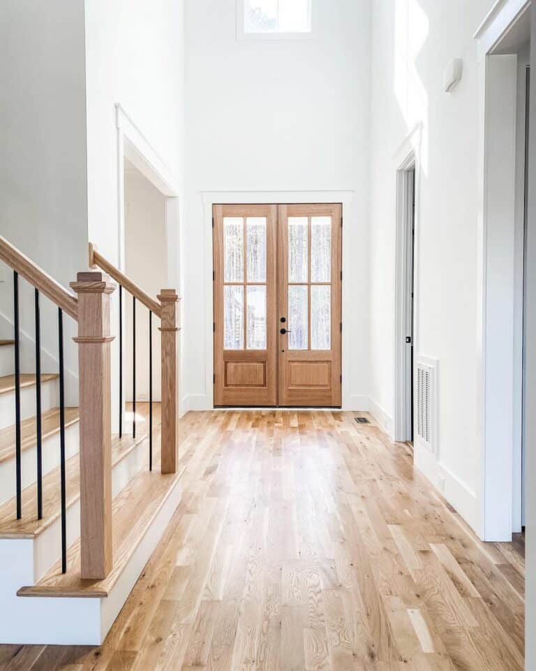 Simple Foyer With Stained Wood Double Doors