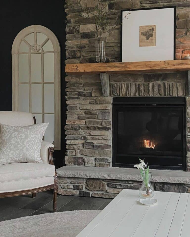 Stacked Stone Fireplace Beside Arched Mirror
