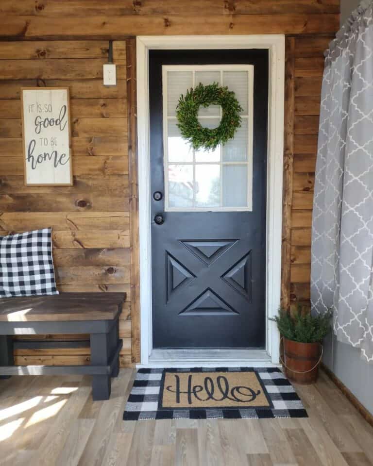 Stained Wood Shiplap Mudroom With Black Entrance Door