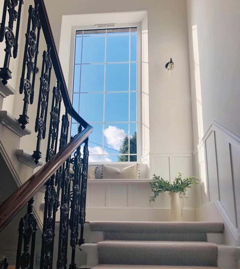 Staircase Landing With a Window Bench