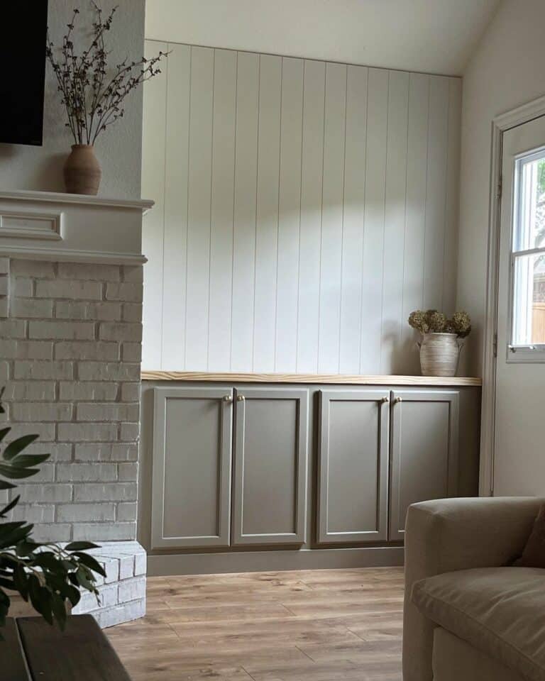 Stone Fireplace With a Muted-green Cabinet