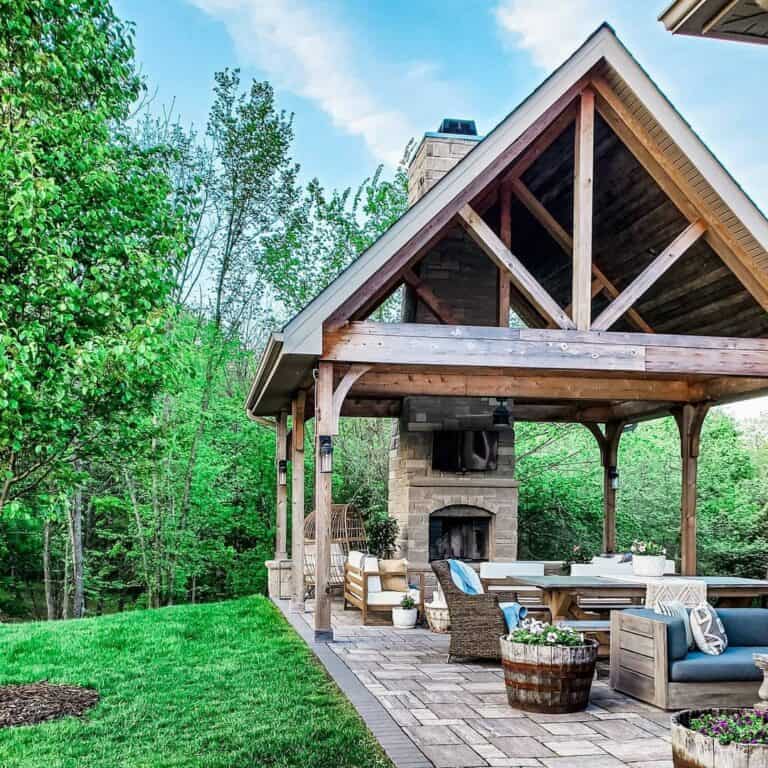 Stone Patio Fireplace With Large Pergola