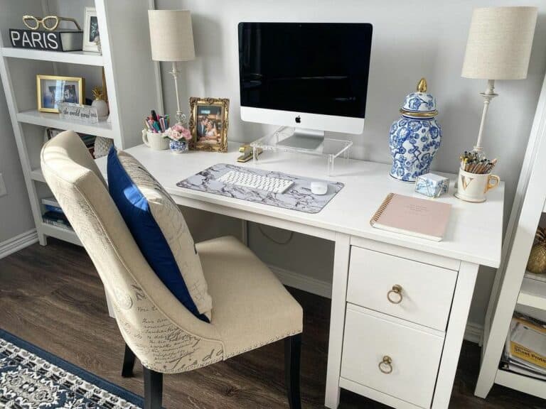 Tall White Bookshelves and a Blue Urn