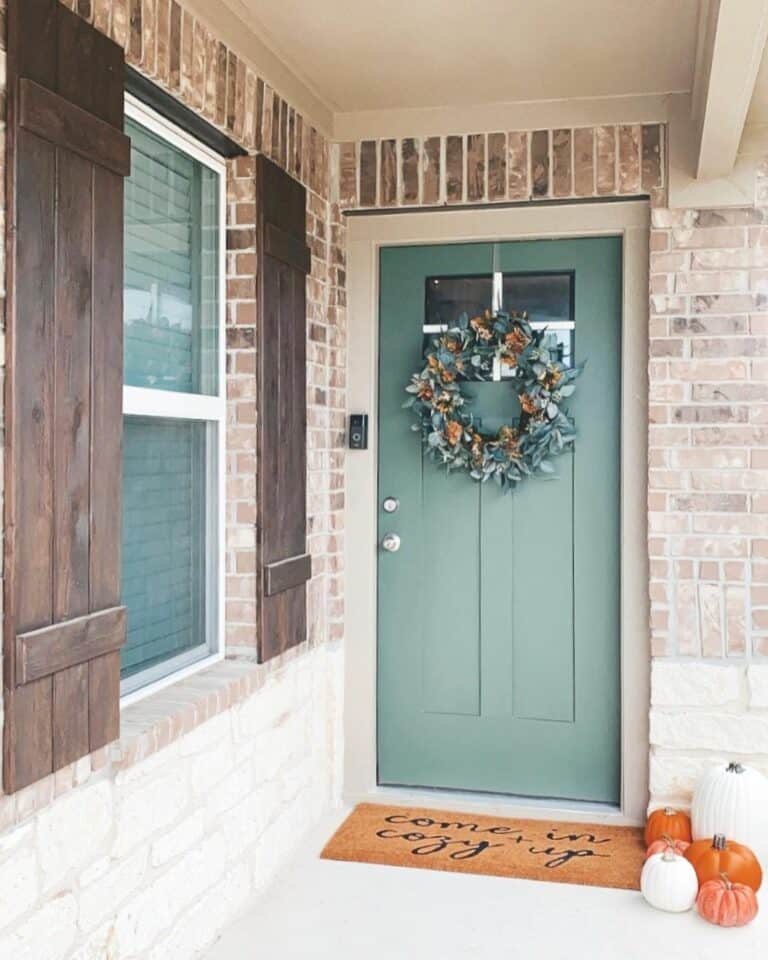 Traditional Green Door With Dark Wood Shutters