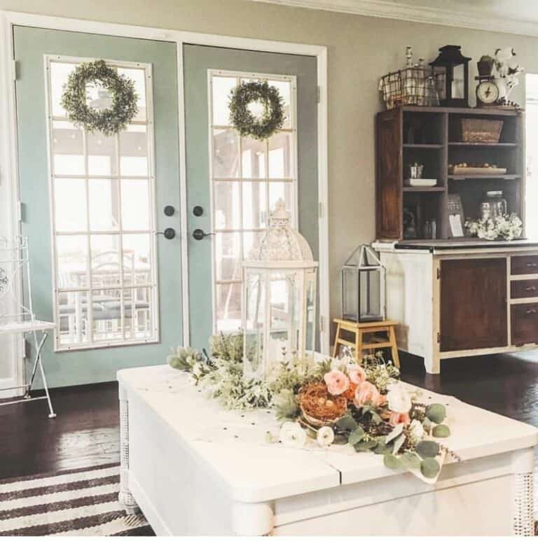 Two Green Wreaths on Mint-colored French Doors