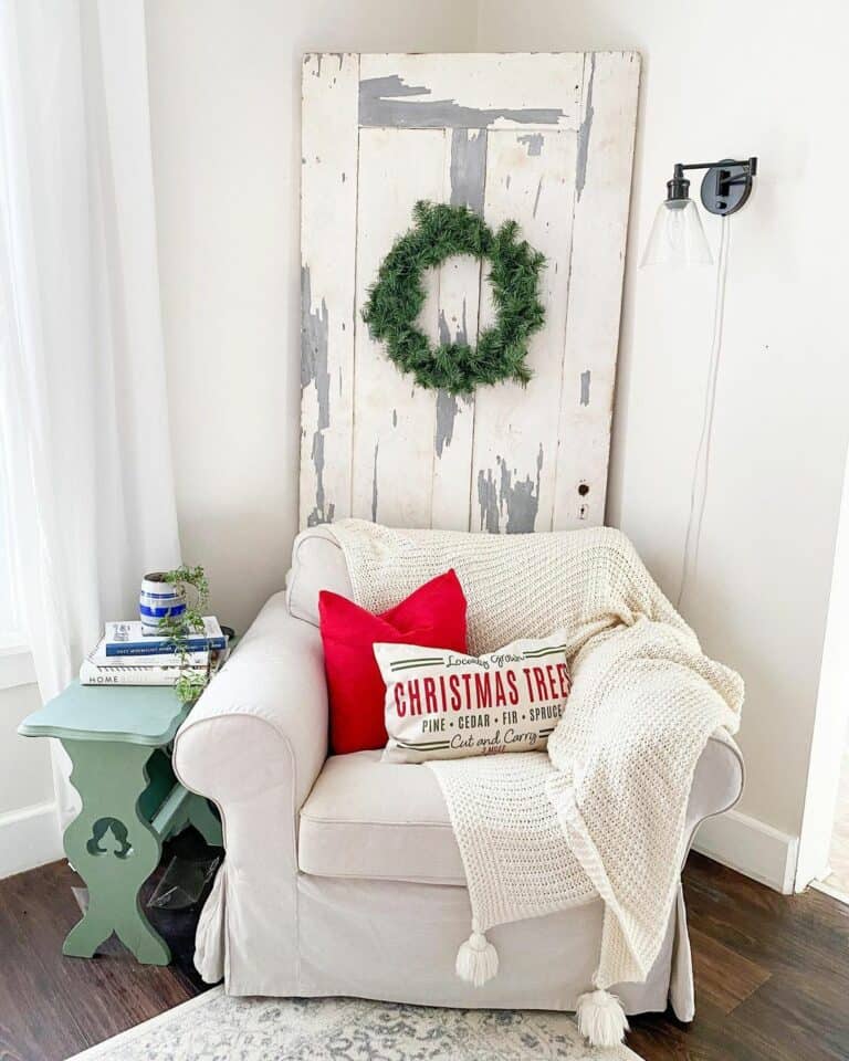 White Arm Chair With Festive Red Accent Pillows