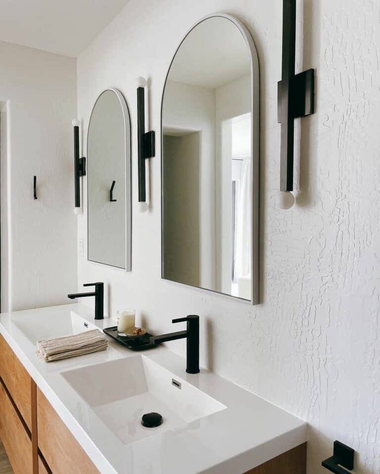 White Bathroom Countertop with Black Faucets