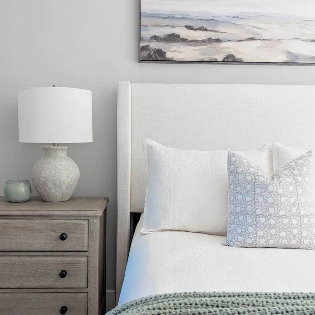 White Bedroom With Coastal Artwork