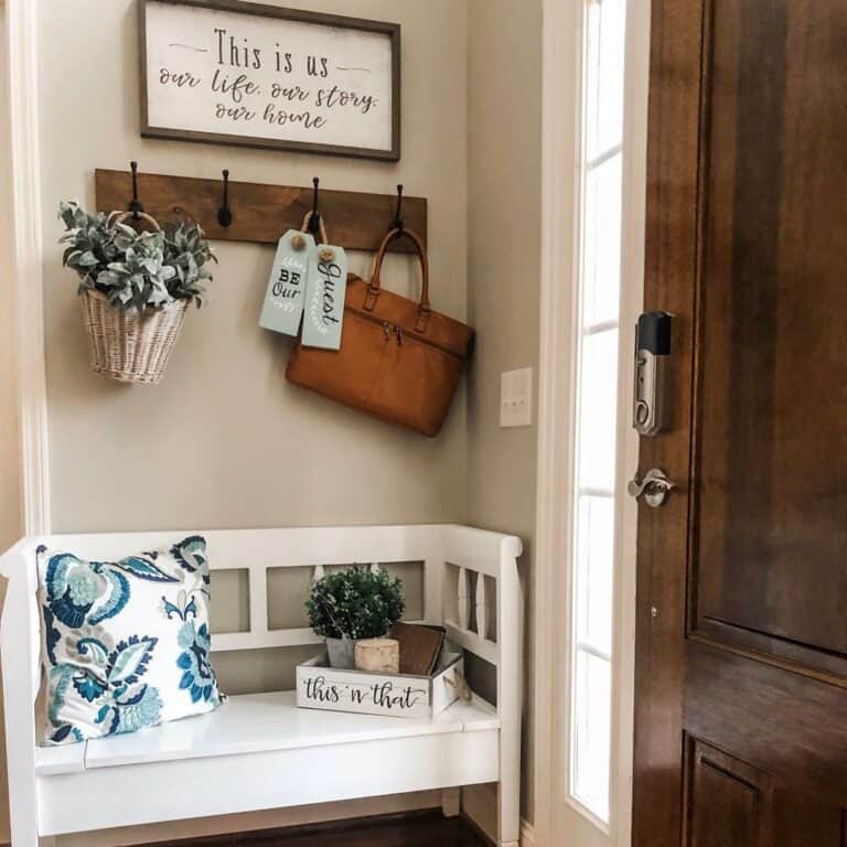 White Bench Under Wooden Hooks