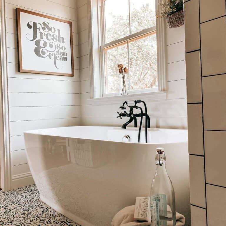 White Freestanding Bathtub With Black Faucet