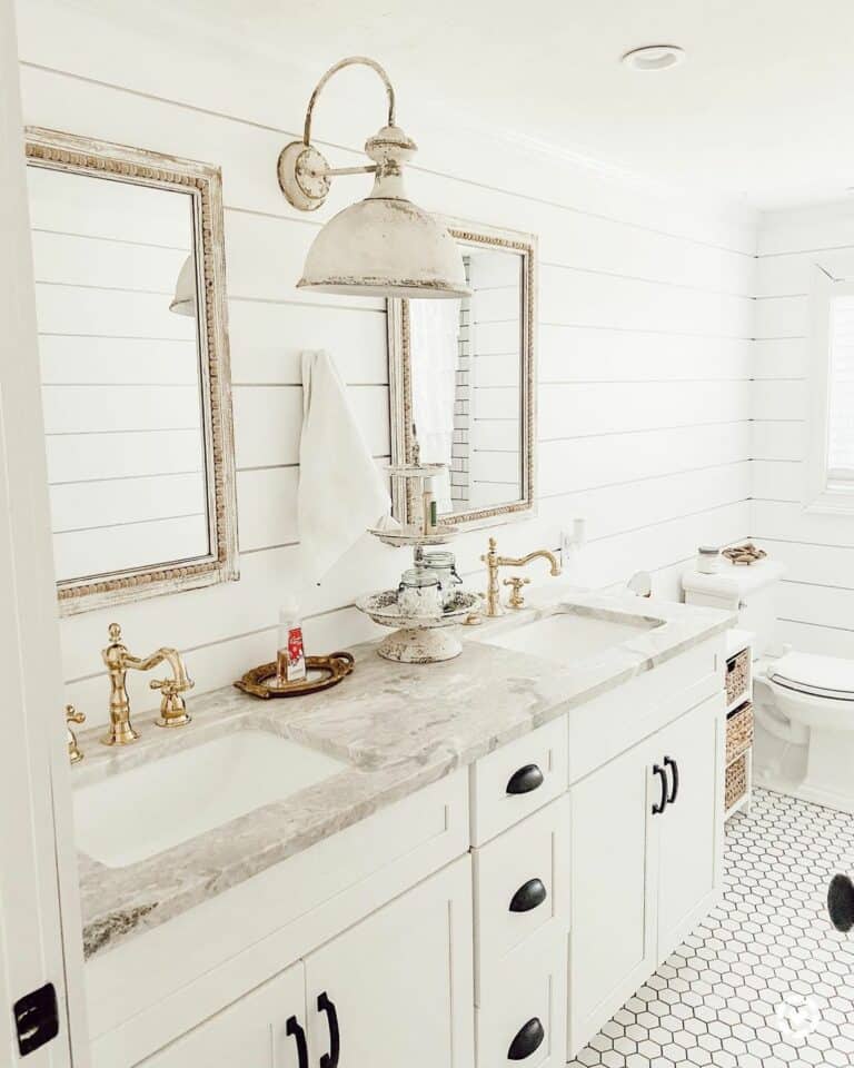 White Marble Bathroom With Gold Faucets