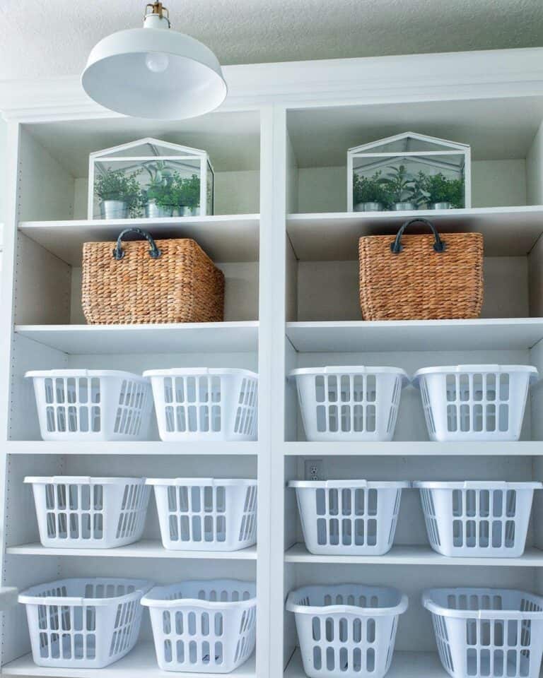 White Open Shelves With White Plastic Laundry Bins