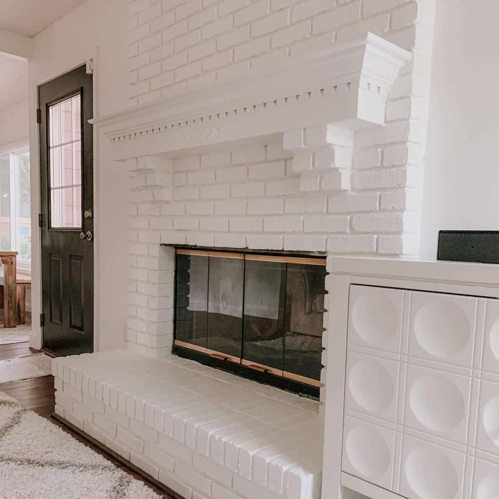 White Painted Brick Fireplace With Glass Doors