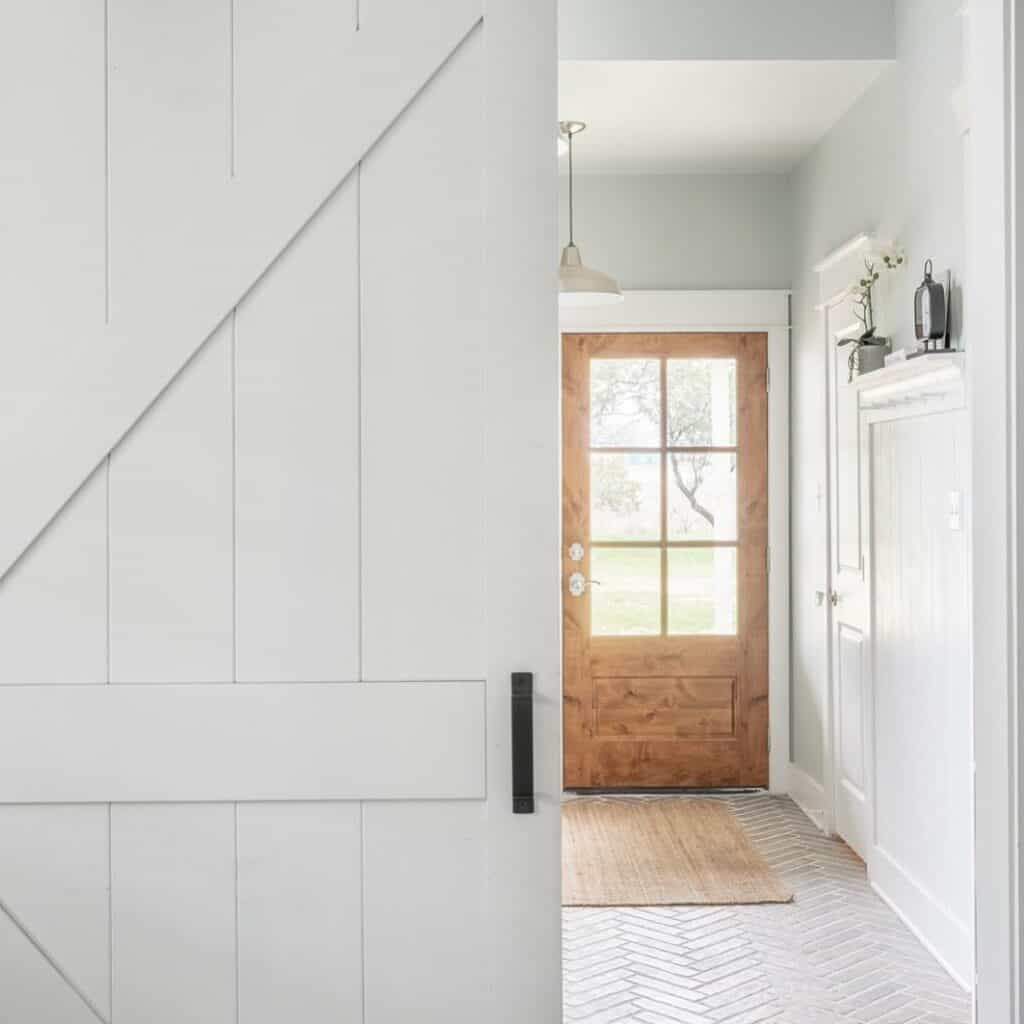White Tiled Entryway With Wood Accents