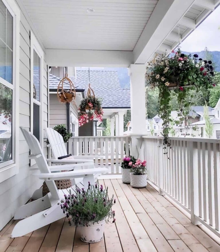White Wooden Railing With Hanging Floral Baskets