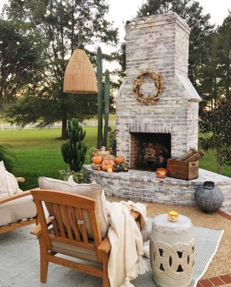 Whitewashed Brick Outdoor Fireplace With Fall Accents